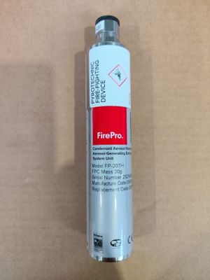 a close up of a fire extinguisor on a cardboard surface
