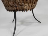 an image of a wicker basket on a stand with a white background