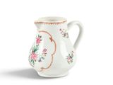 a white pitcher with a floral design on it