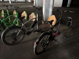 many bikes that are parked in a row in a parking garage