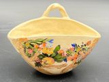 a small bowl with flowers painted on it on a table