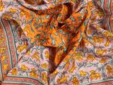 un gros plan sur un tissu à motifs cachemire orange et verts