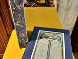 a book sitting on a yellow table next to a chair