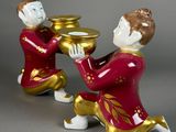 pair of figurines of a man and a woman holding a bowl