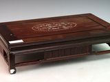 an image of a small wooden box with a design on it