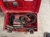 a red tool box with tools in it on the floor