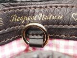 a close up of a purse with a ring on it