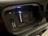 a close up of a car ' s charging station with a blue light