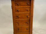 a wooden chest of drawers with four drawers on each side