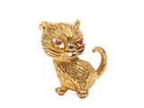 une image représentant une broche en forme de chat en or aux yeux rouges
