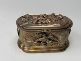 a silver box with a design on it on a white surface
