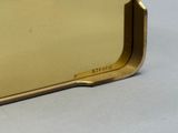 a gold metal box with a handle on a table