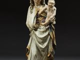 a statue of a woman holding a child in her arms