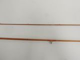 two old fishing rods hanging on a wall in a room