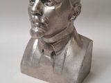 silver metal bust of a man wearing a suit and tie