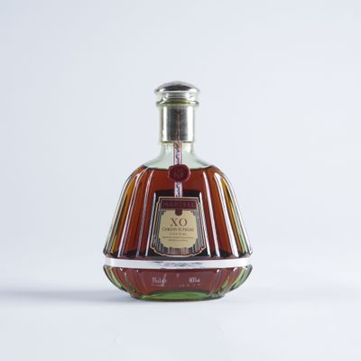 a bottle of brandy sitting on a white surface