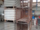 a large stack of metal crates in a warehouse