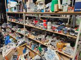 shelves filled with assorted items in a room with a lot of clutter