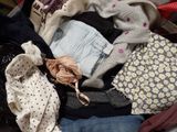 a suitcase full of clothes and clothes sitting on the floor