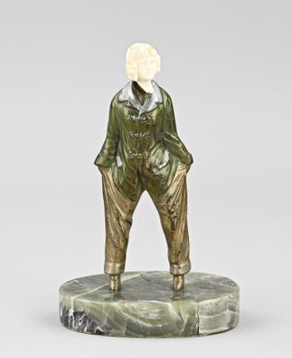 statue of a man standing on a marble base with his hands in his pockets