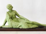 statue of a woman with a dog on a wooden base
