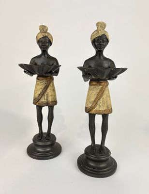pair of bronze figurines of a woman reading a book and a man reading a book