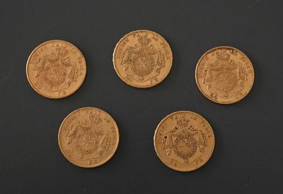 four different types of coins are shown on a black surface