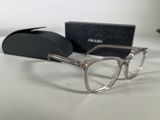 prada eyeglasses are displayed on a white surface next to a black box