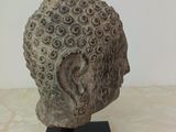 sculpture of a head of a man with a beard on a black stand