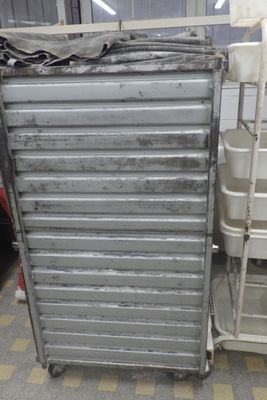 a metal cart that is sitting next to a stack of chairs
