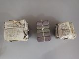 three pieces of paper are wrapped in twine and tied with twine