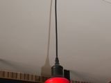 a red light hanging from the ceiling of a coffee shop