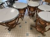 four drums sitting on the floor in a room