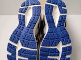 the soles of a pair of blue and white running shoes