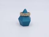 yellow gold and diamond ring on a blue hexagon