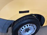 a close up of a tire on a yellow car