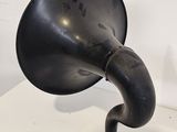 a black antique phonom on a white table