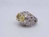 an image of a yellow and white diamond ring on a white surface