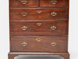 a mahogany chest of drawers with brass handles