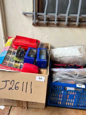 a box of assorted items sitting on the floor next to a window