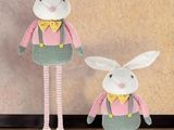 two stuffed animals are standing next to each other on a wooden floor