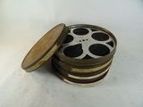 une pile de bobines de film posée sur une surface blanche