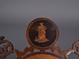 carvings on the back of a chair with a picture of a woman on it