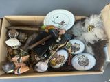 a cardboard box filled with assorted items and a stuffed animal