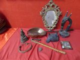 a table with a mirror, a mirror, a bowl, a spoon, and other items on it