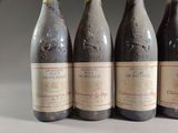 four bottles of wine are lined up on a table
