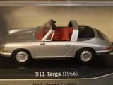 a silver toy car with a red seat in a display case