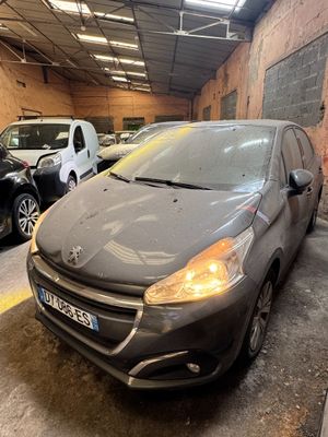 the grey car is parked in the garage next to other cars