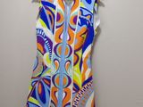 a dress hanging on a hanger on a wall