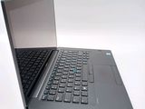 a laptop computer that is open on a white surface